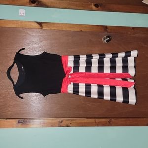 Sleeveless black and cream dress with reddish ribbon